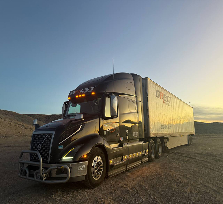 Black OREST Express truck parked against the sunset