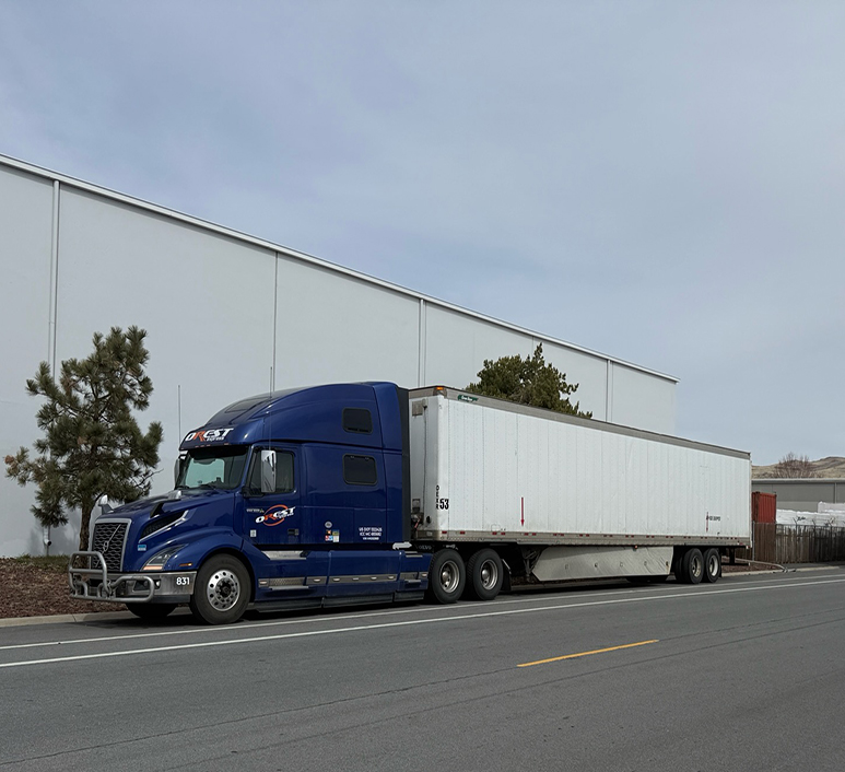Blue OREST Express truck parked near a commercial building