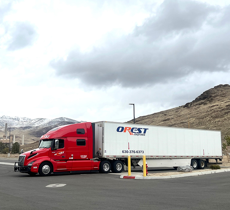 Red OREST Express truck standing at a truck stop in the mountains